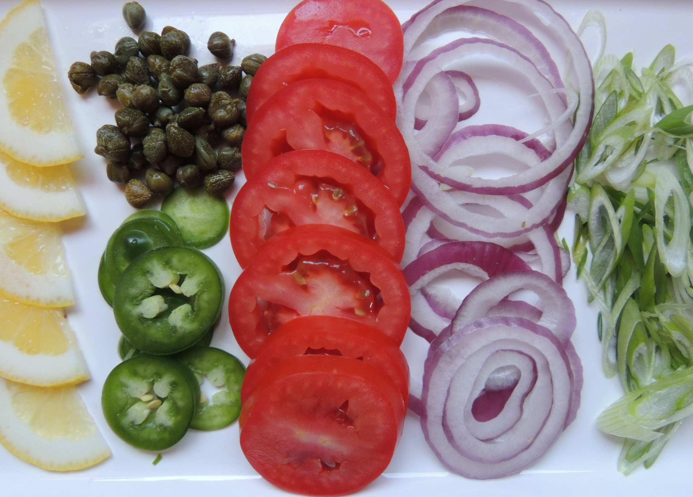 Sliced vegetables and capers for bagel toppings