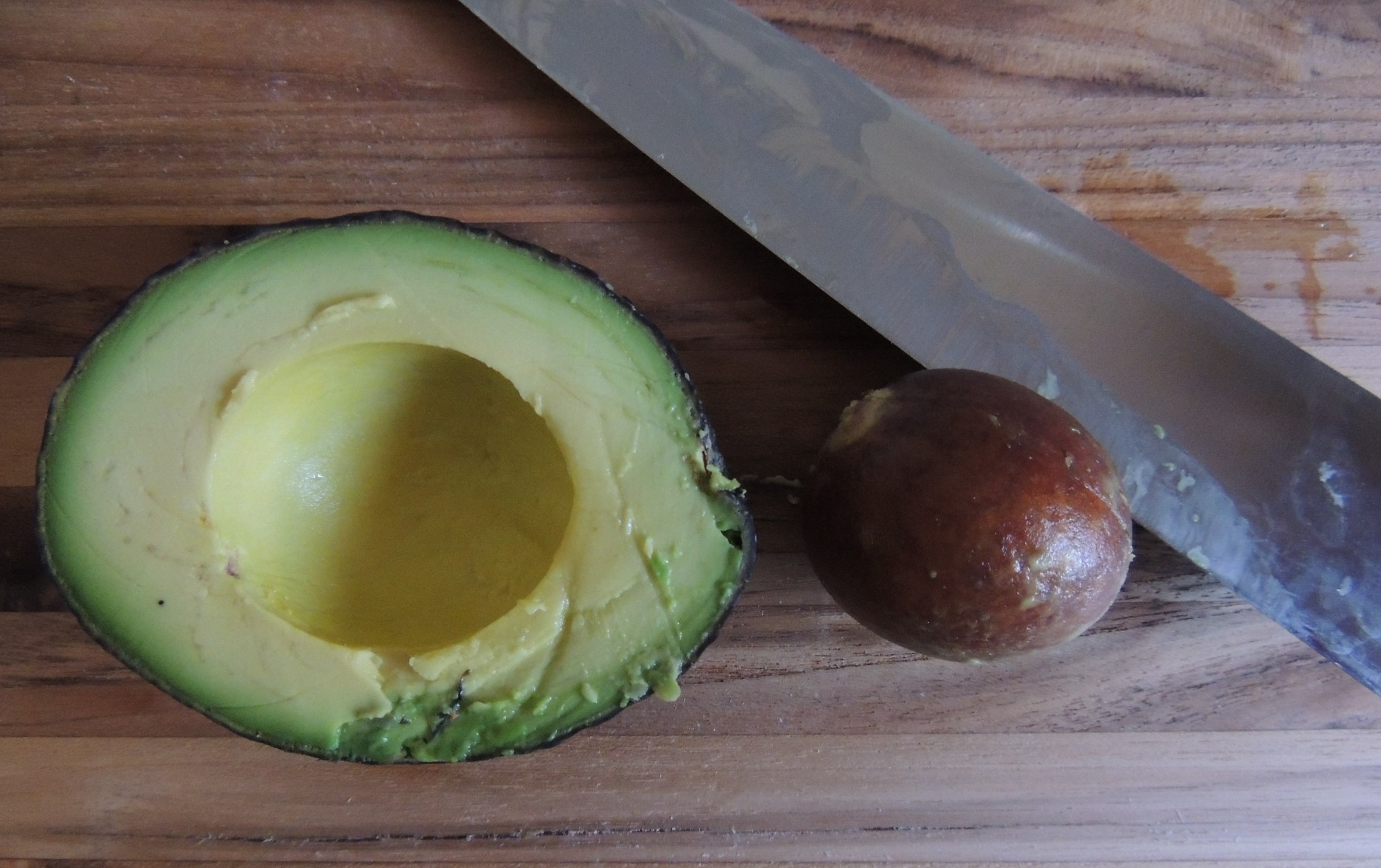 Avocado pit removed with a knife