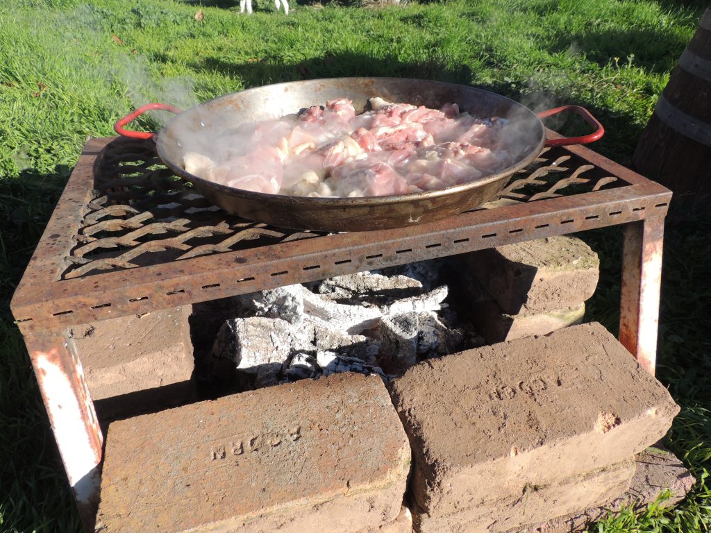 Searing chicken over a Tuscan grill