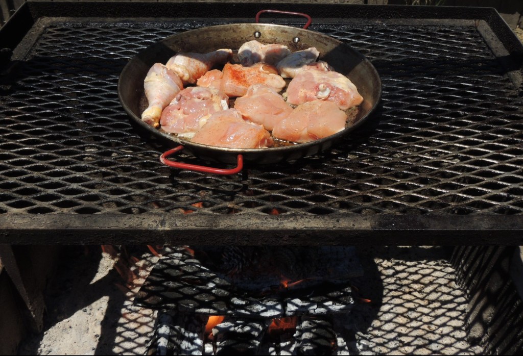 Chicken searing over an oak fire