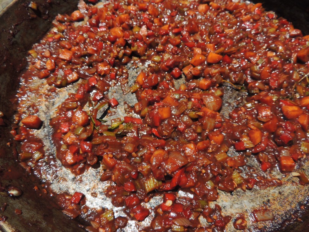 Caramelized vegetables and tomato paste in a paella pan