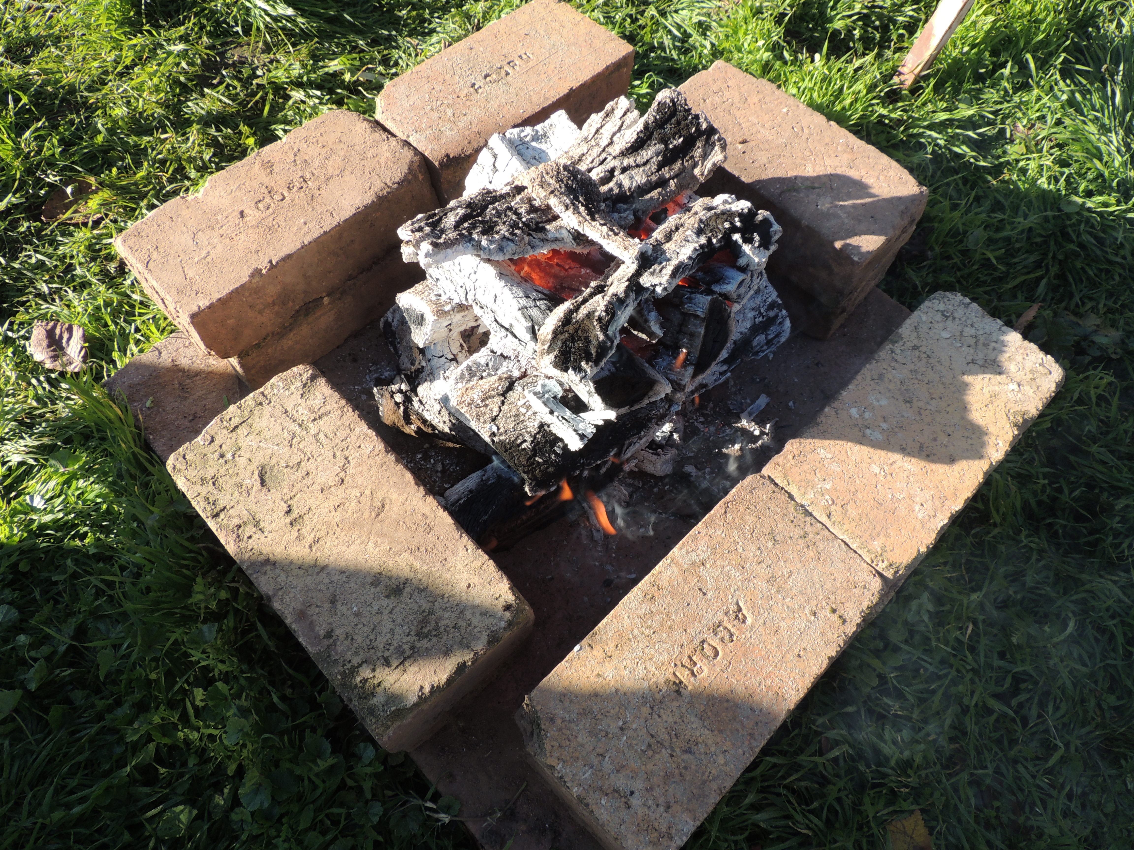 A fire surrounded by fire bricks for a Tuscan grill
